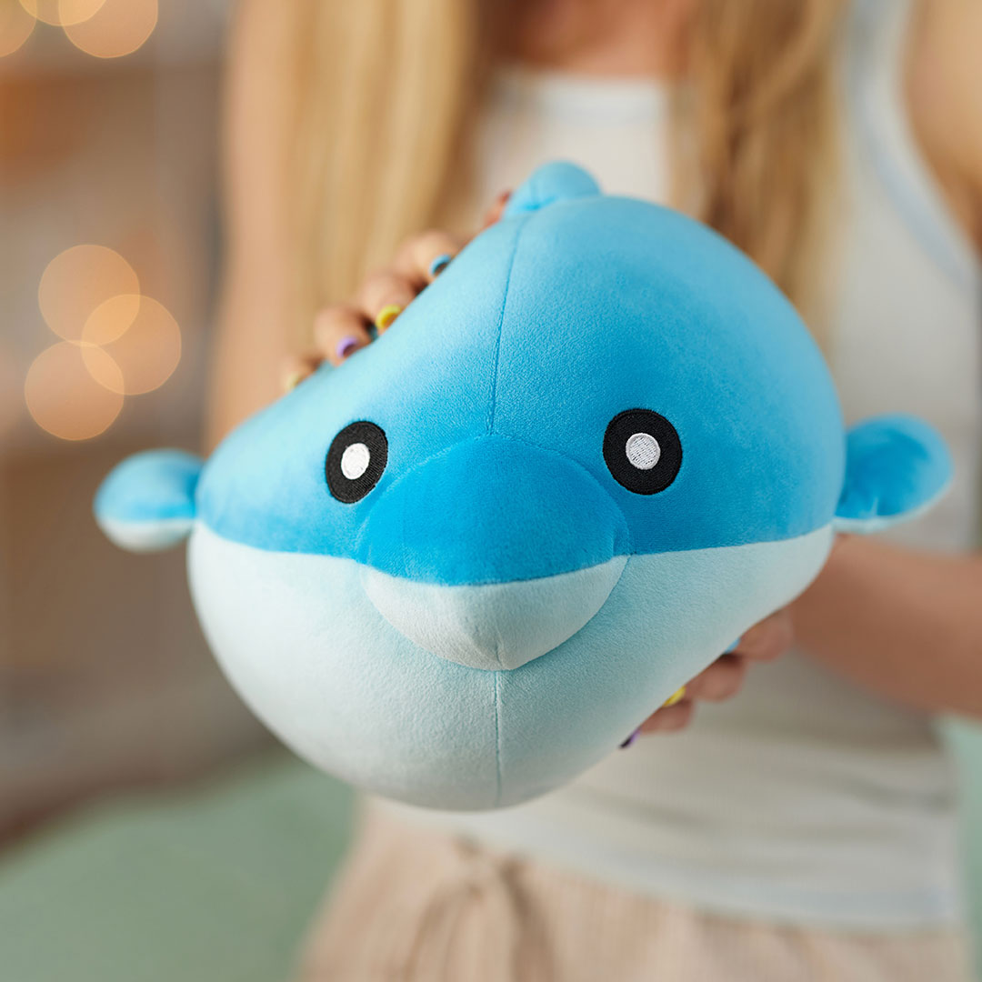 girl squeezing soft plushie