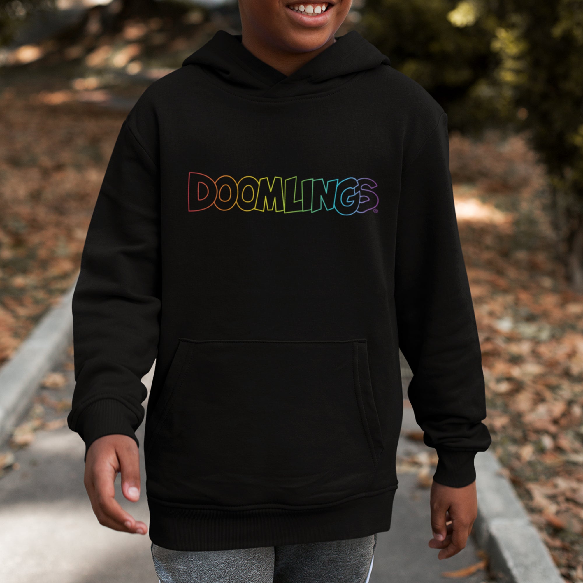 kid wearing black hoodie with rainbow doomlings logo