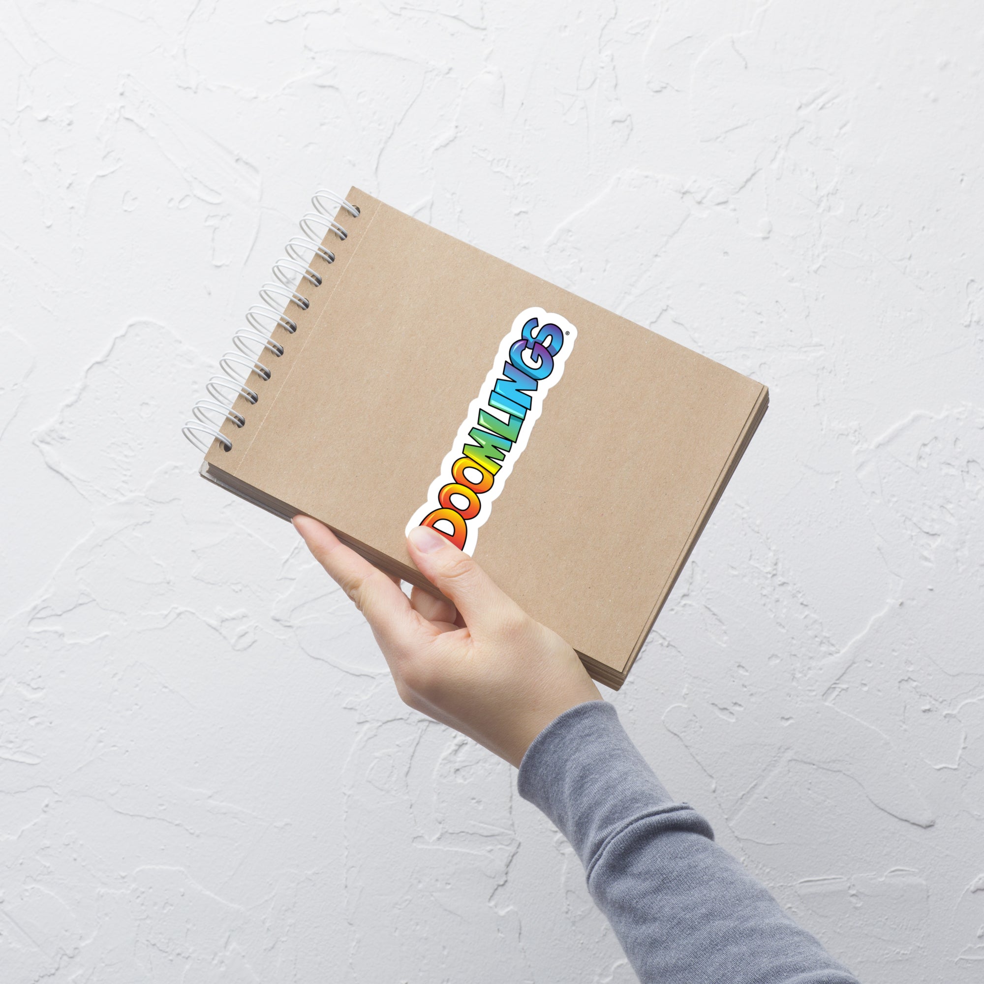  doomlings logo sticker on a notebook