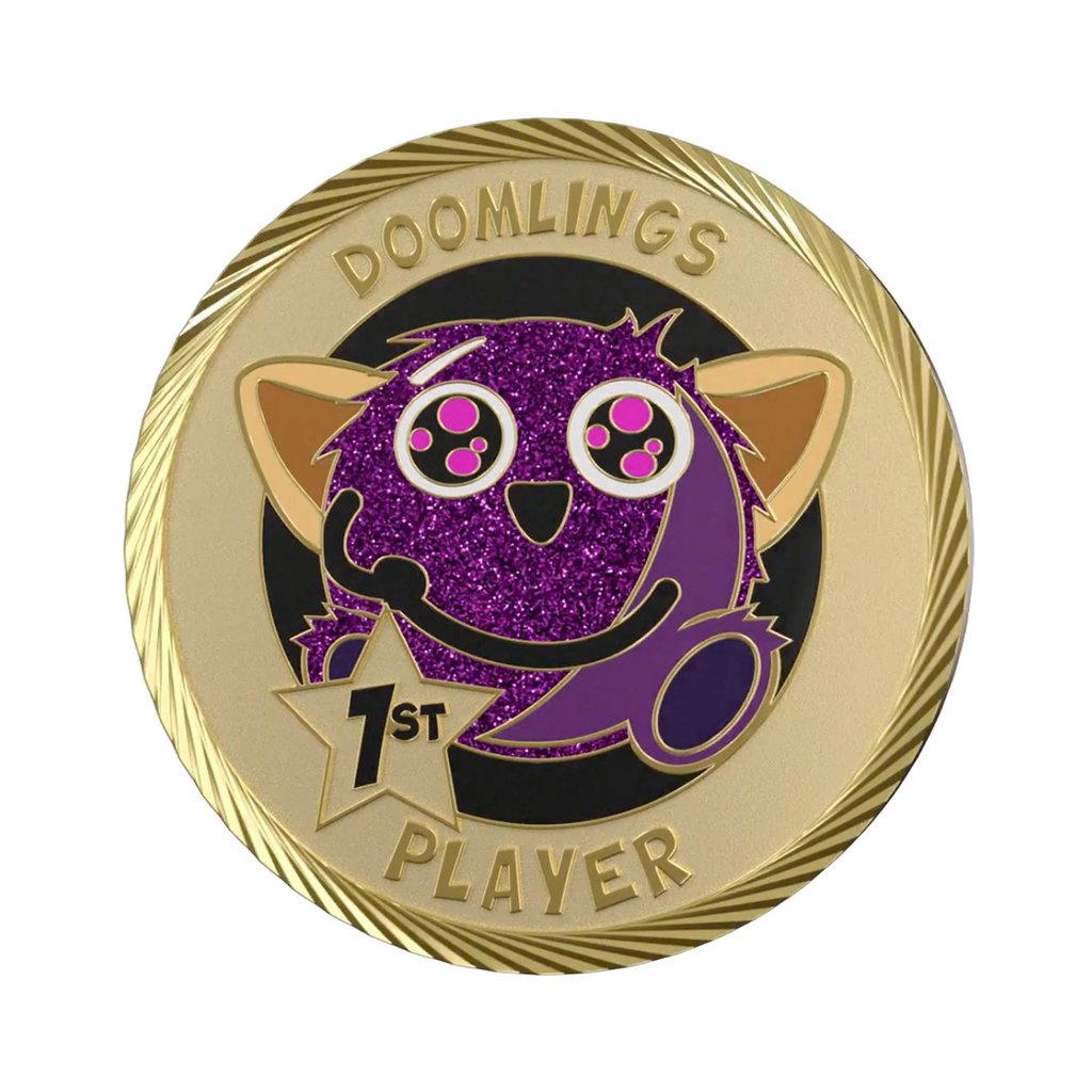 playful doomlings first player medallion coin, gold coin that says doomlings 1st player with cute purple guy